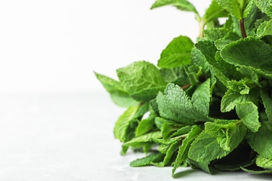 Bunch of fresh green mint on table, closeup. Space for text