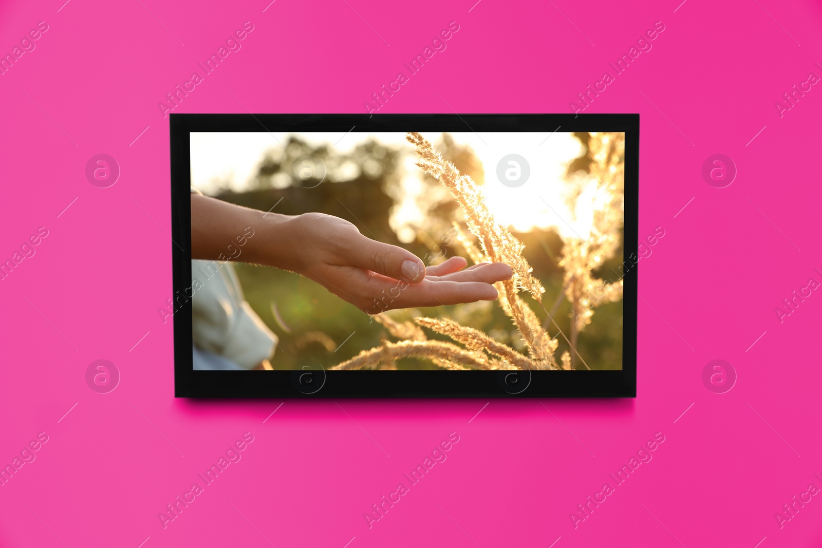 Image of TV screen with movie frame on pink wall