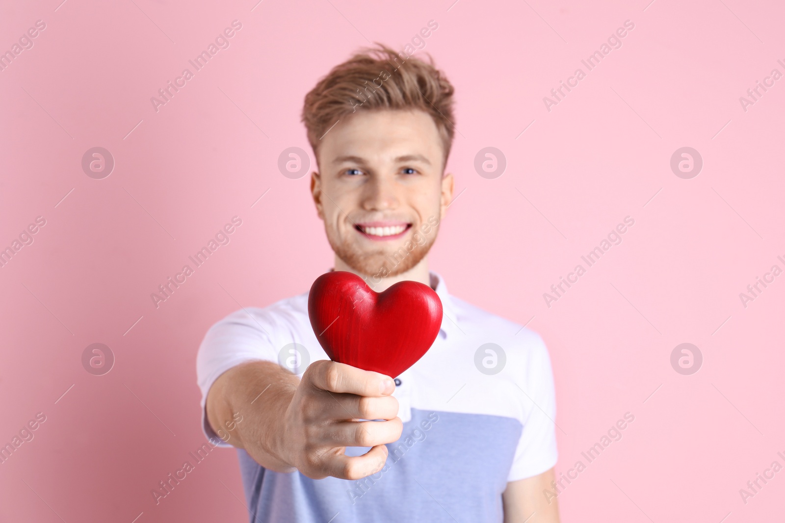 Photo of Portrait of young man with decorative heart on color background