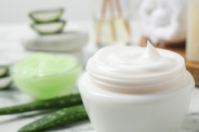 Open jar of aloe cream on table, closeup. Organic cosmetics