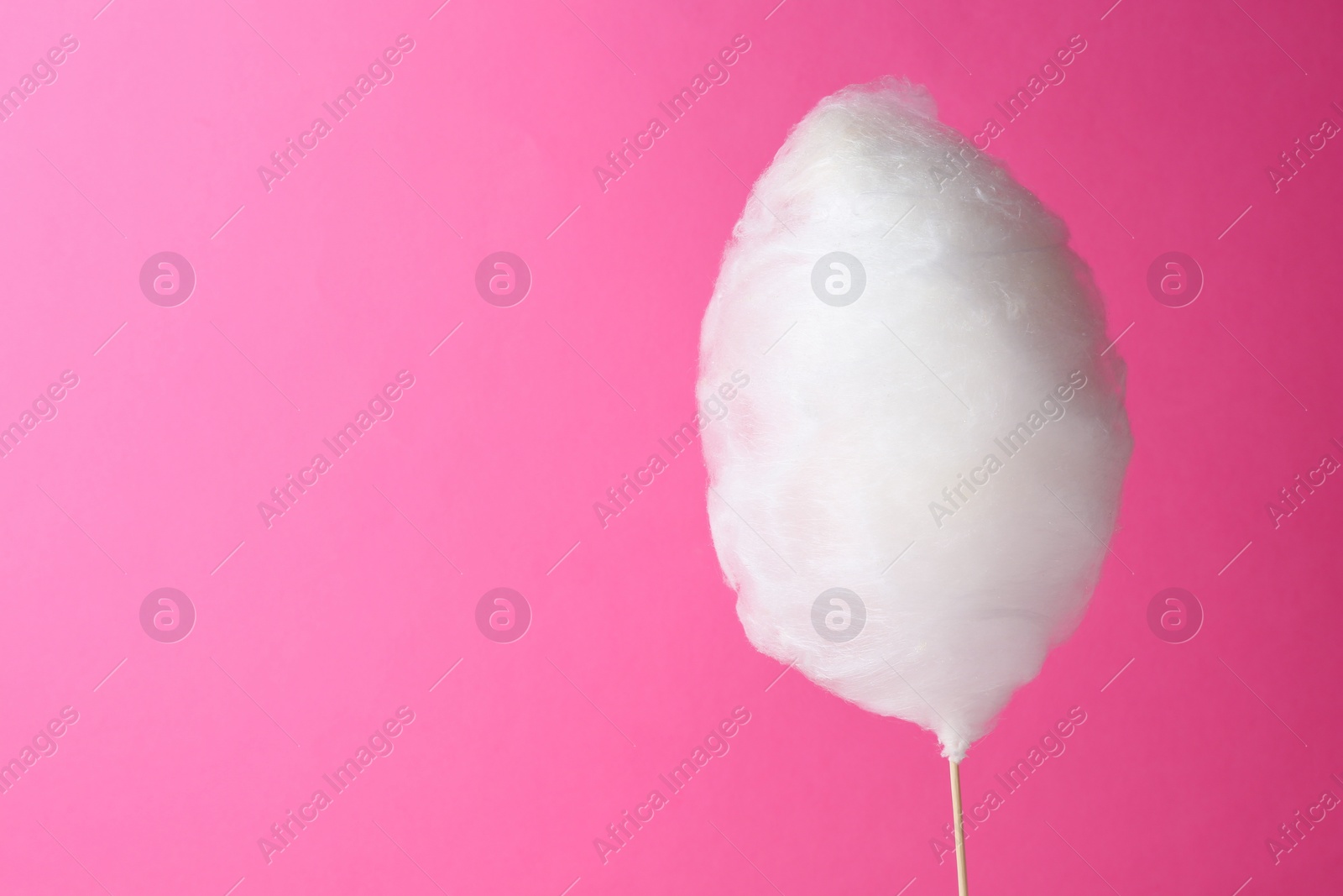 Photo of One sweet cotton candy on pink background