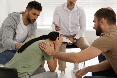 Photo of Group of drug addicted people at therapy session indoors