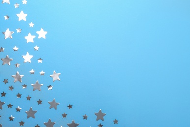 Confetti stars with space for text on blue background, top view. Christmas celebration