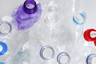 Photo of Many crumpled bottles as background, closeup. Plastic recycling