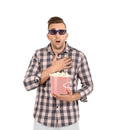 Emotional man with 3D glasses and popcorn during cinema show on white background