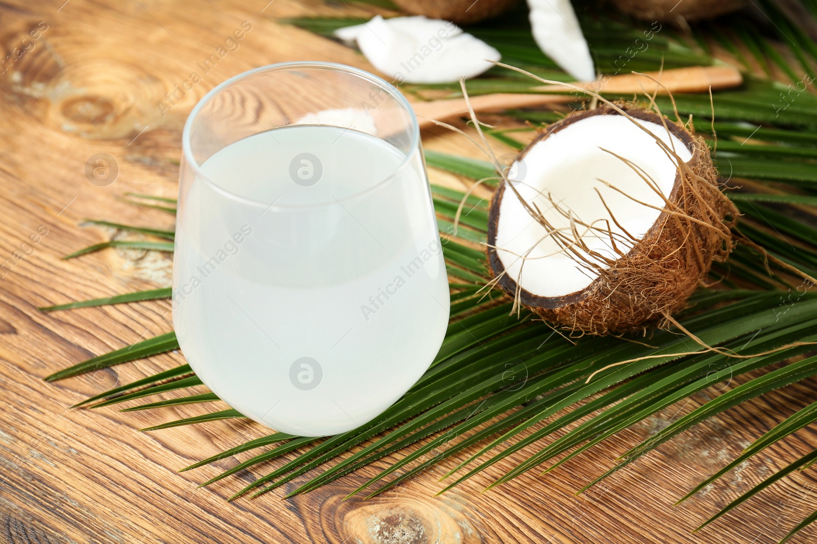 Photo of Glass of coconut water on wooden table