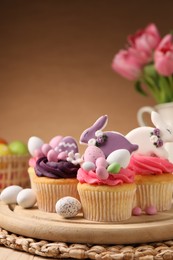 Photo of Tasty cupcakes with Easter decor on table