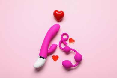 Flat lay composition with sex toys on pink background