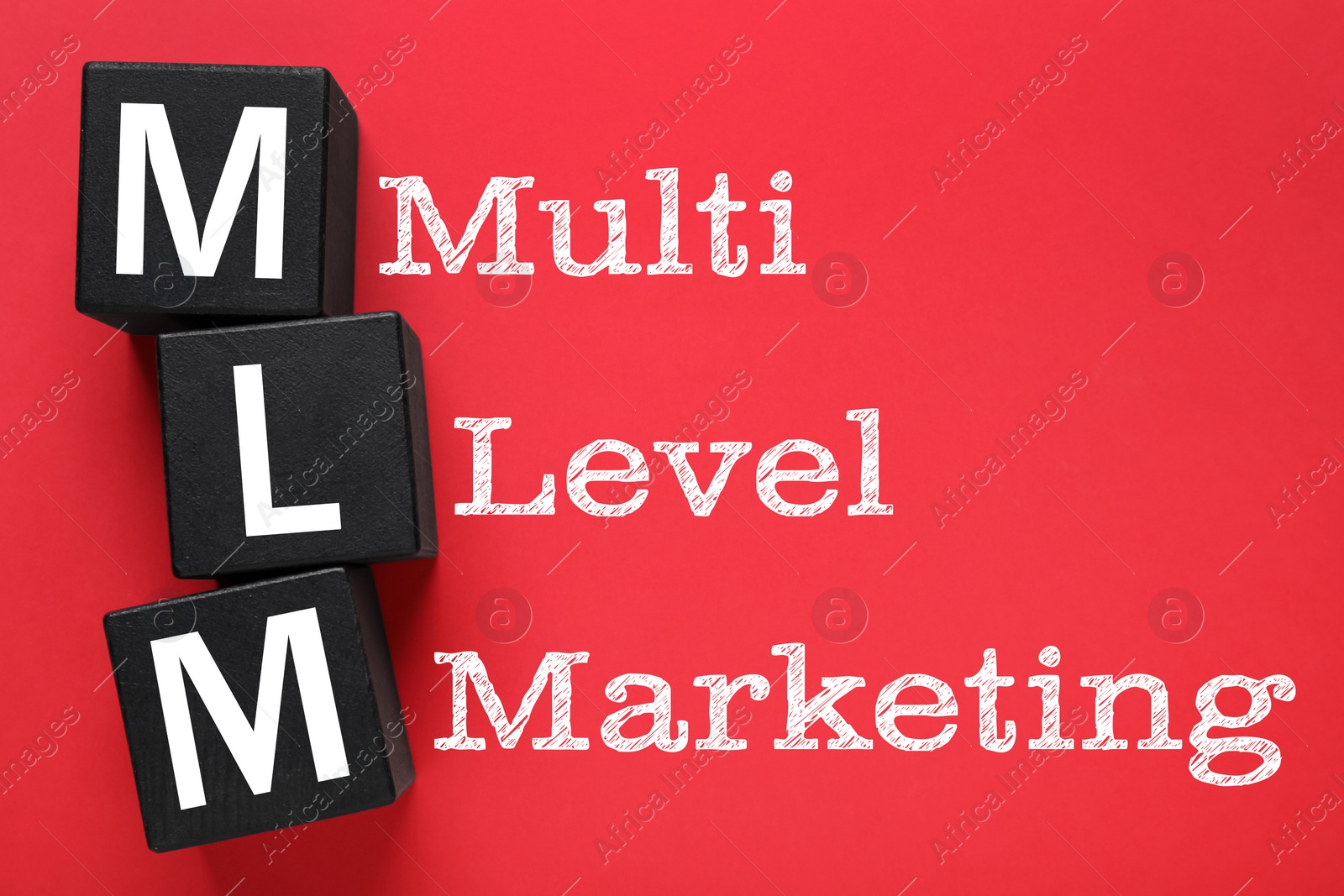 Image of Multi-level marketing. Abbreviation MLM of cubes with letters on red background, top view