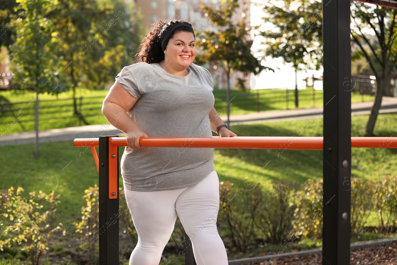 Photo of Beautiful overweight woman training on sports ground