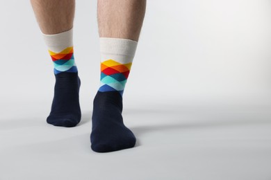 Photo of Man in stylish colorful socks on white background, closeup. Space for text
