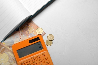 Image of Money, calculator and notebook on light table, flat lay. Space for text 