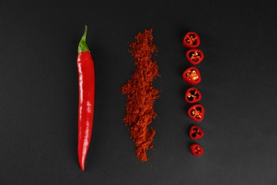 Ground red pepper and ingredient on black background, flat lay