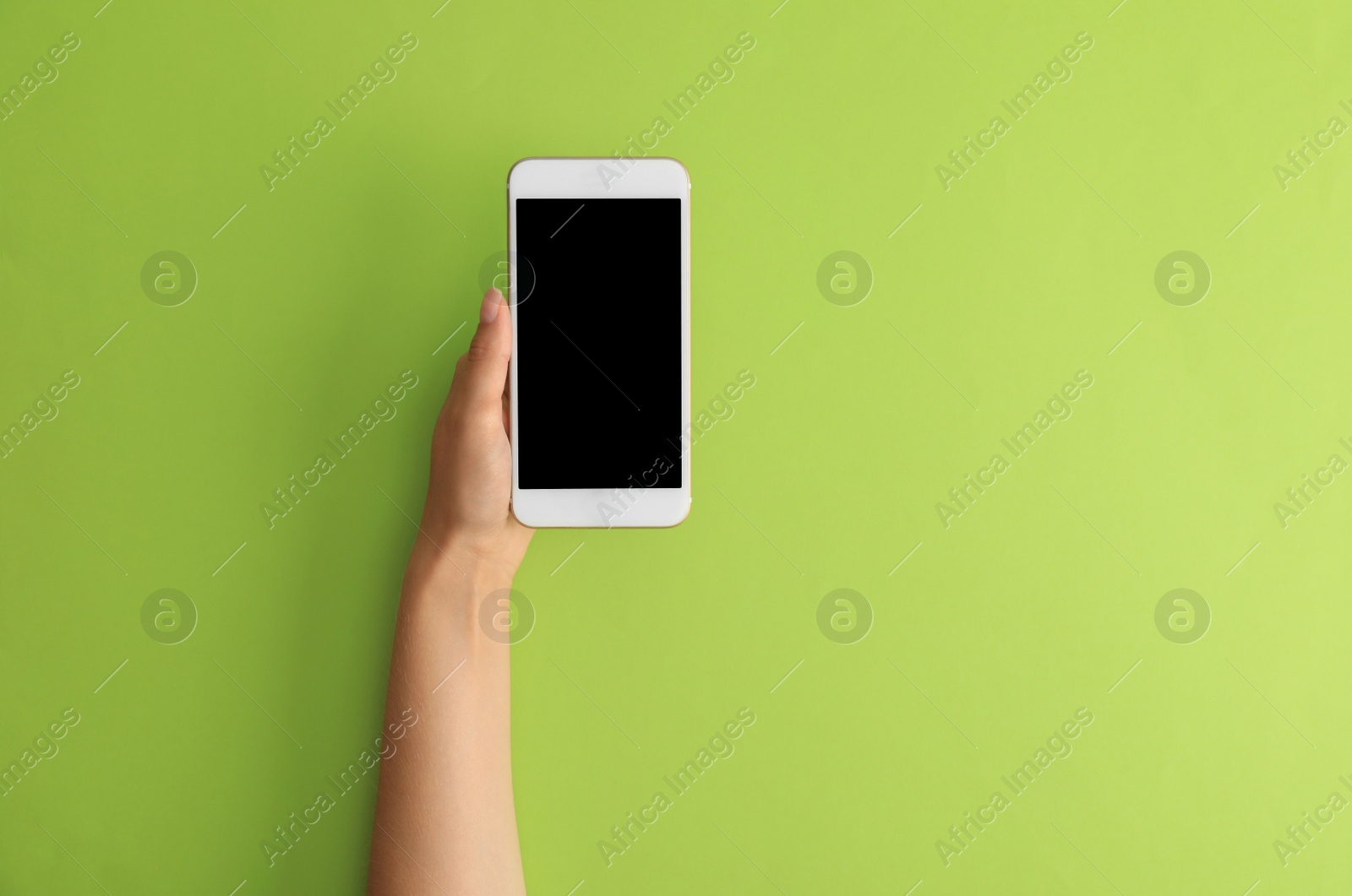 Photo of Woman holding modern phone on green background, top view. Space for text