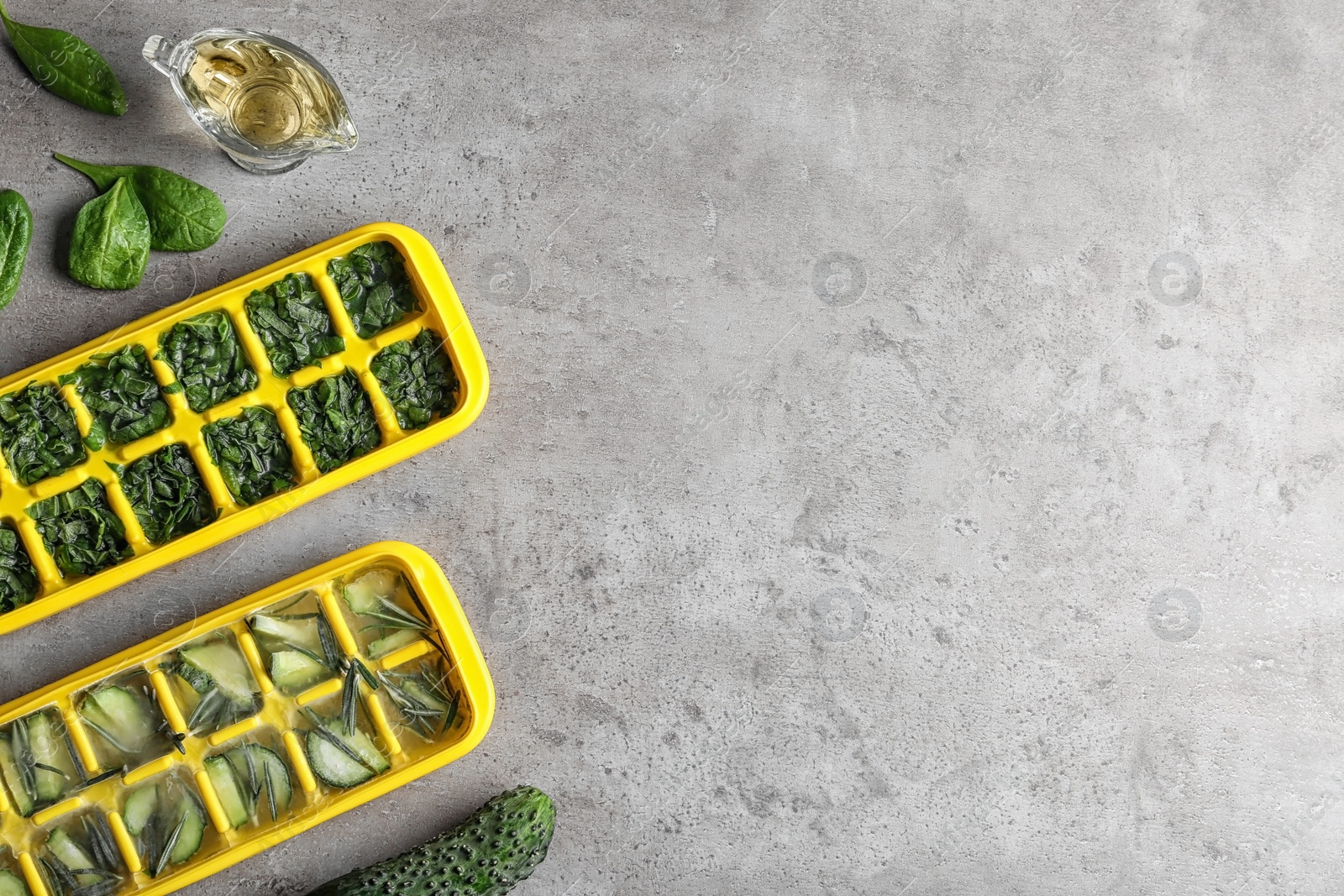 Photo of Flat lay composition with ice cube trays and space for text on table