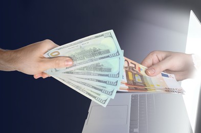 Online money exchange. Woman holding dollars and man giving euro banknotes to her through laptop screen, closeup