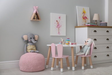 Photo of Children's room with modern furniture and pictures. Interior design
