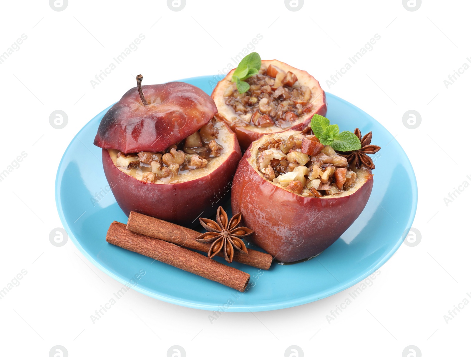 Photo of Tasty baked apples with nuts, honey, spices and mint isolated on white