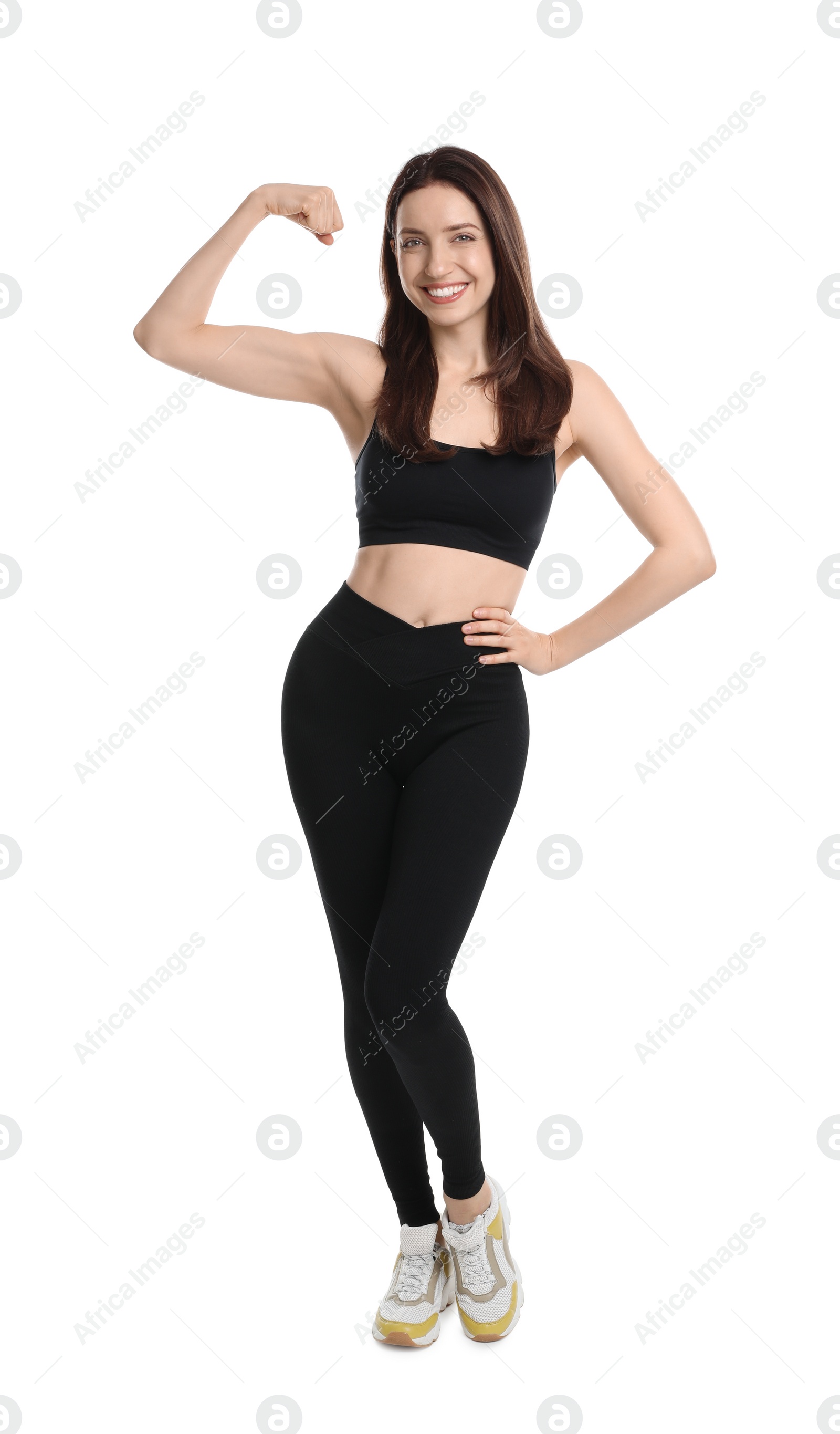 Photo of Happy young woman with slim body showing muscles on white background