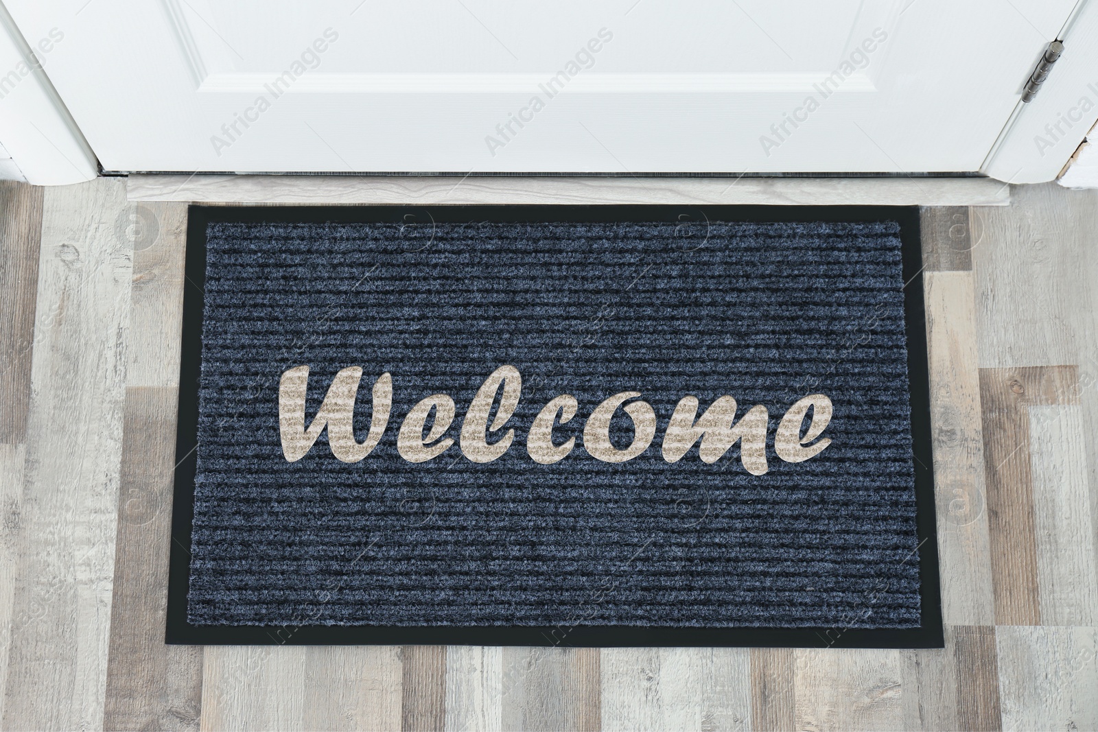 Image of Door mat with word WELCOME near entrance, top view