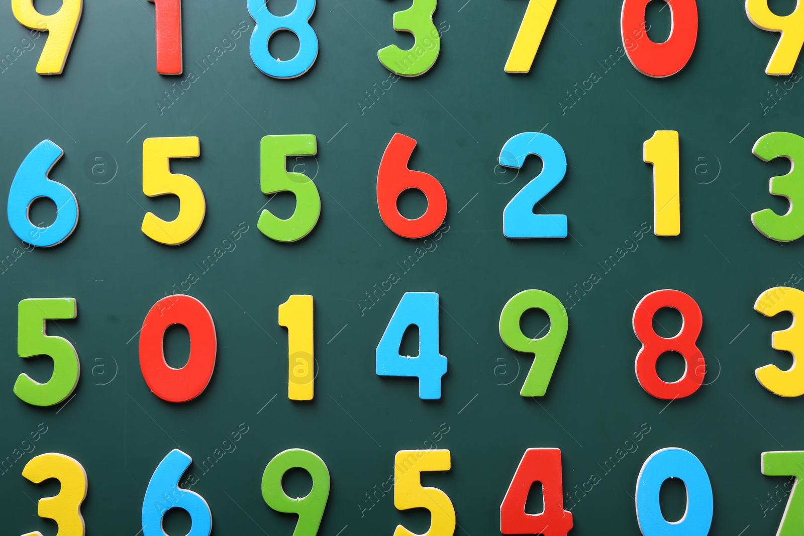 Photo of Colorful numbers on green background, flat lay