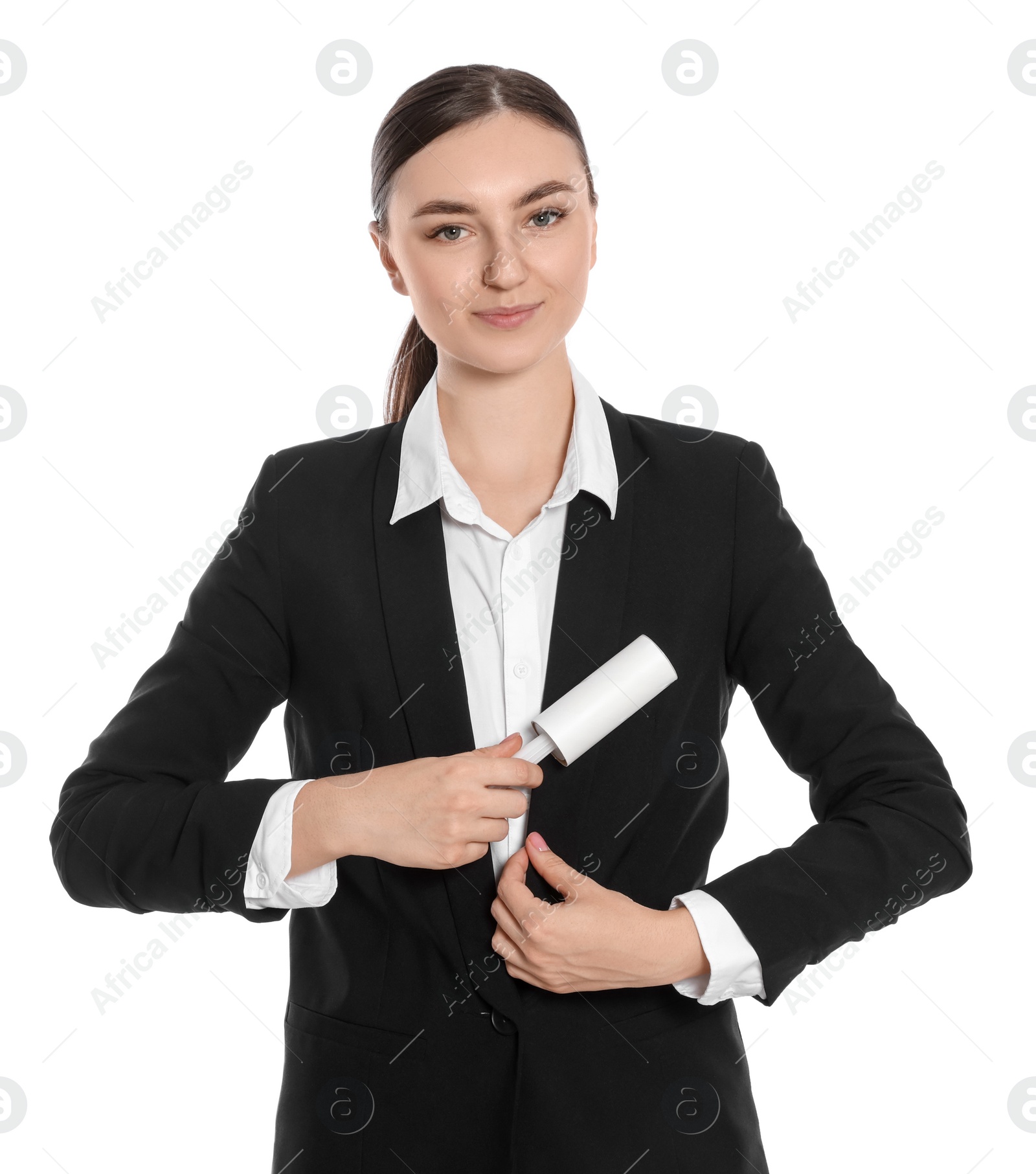 Photo of Young woman cleaning suit with lint roller on white background