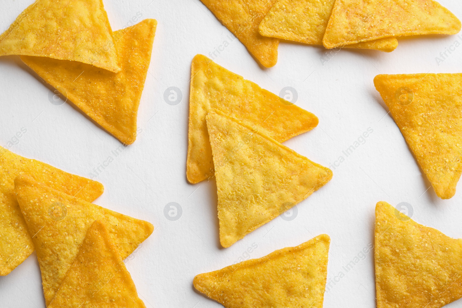 Photo of Flat lay composition of tortilla chips (nachos) on white background