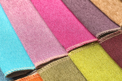 Photo of Fabric samples of different colors for interior design as background