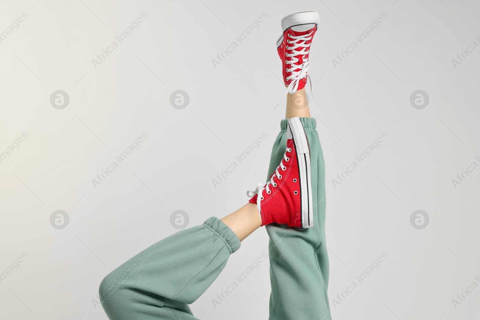 Photo of Woman in stylish gumshoes on white background, closeup. Space for text