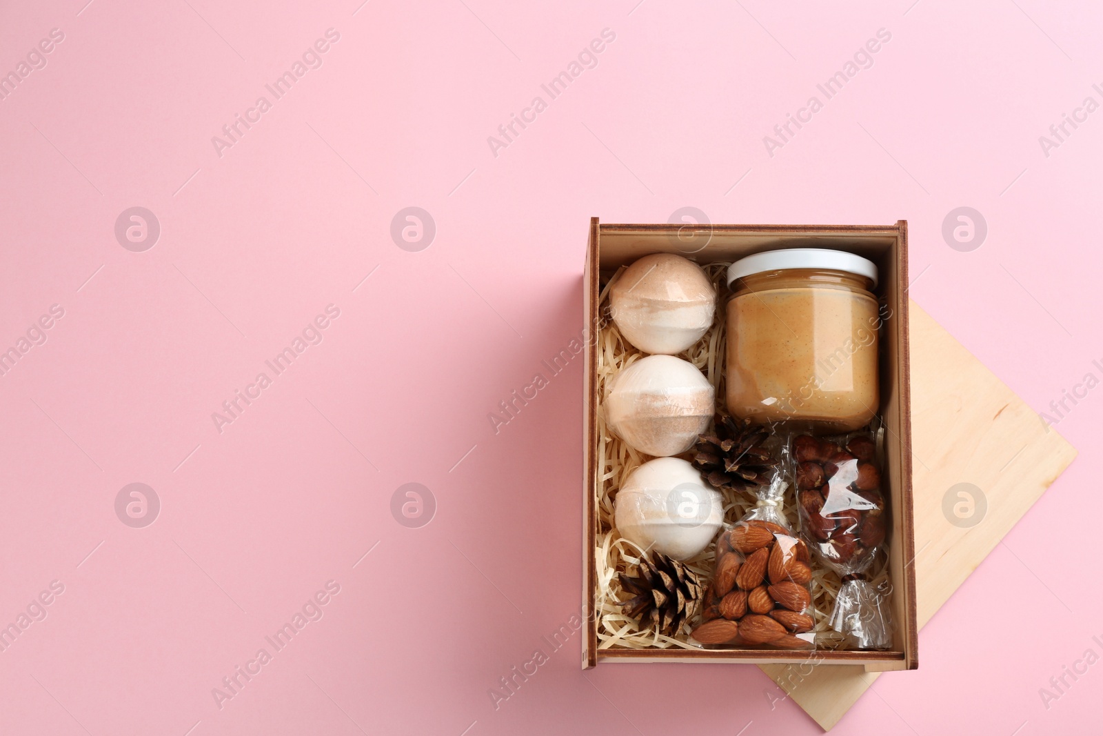 Photo of Stylish gift set on pink background, flat lay. Space for text