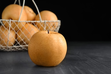 Ripe apple pear on black table. Space for text