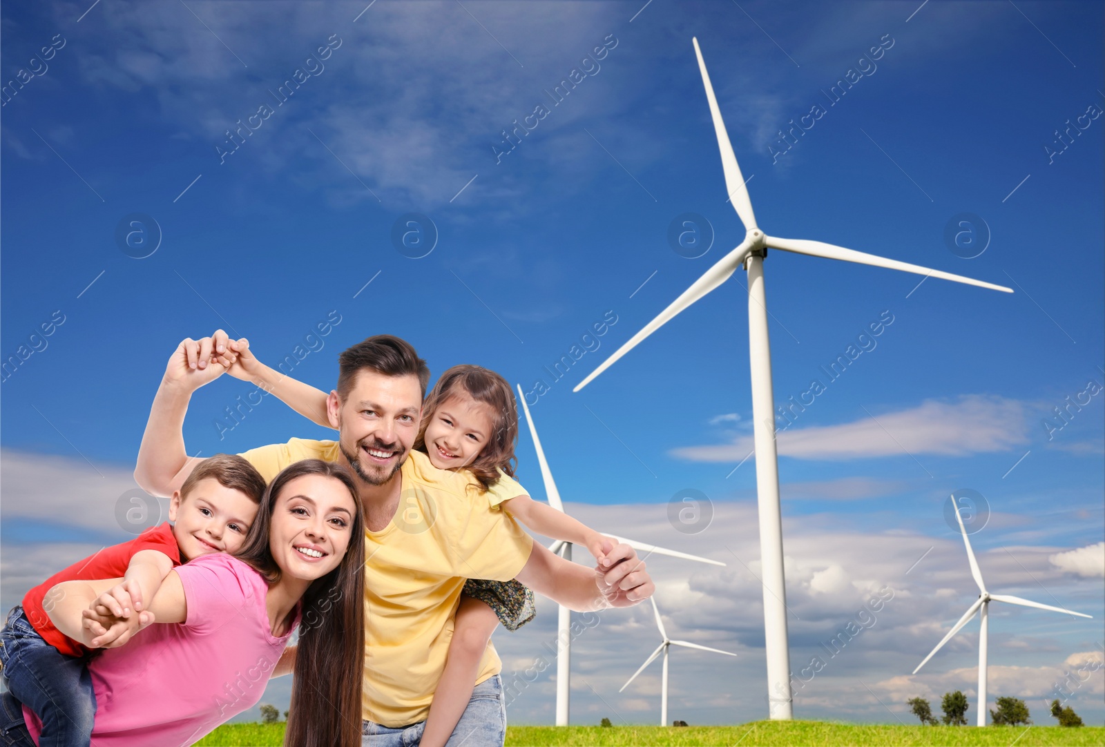 Image of Happy family with children and view of wind energy turbines on sunny day