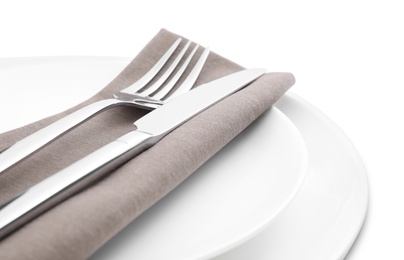 Photo of Plates with clean cutlery and napkin isolated on white