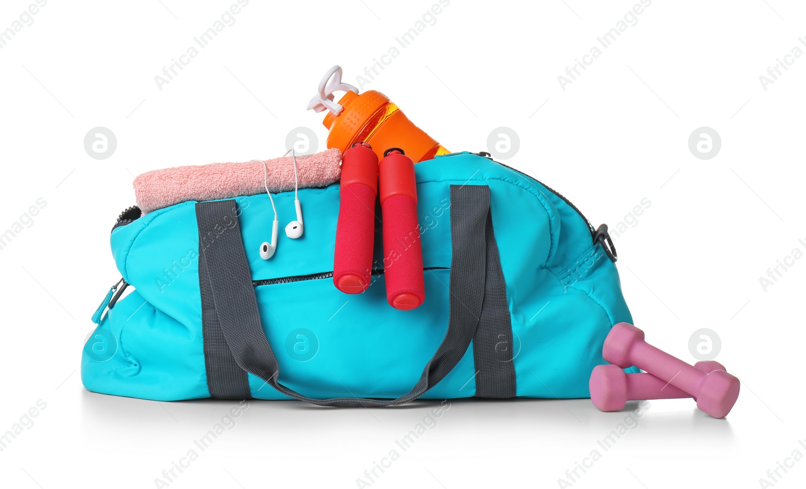 Photo of Sports bag and gym equipment on white background