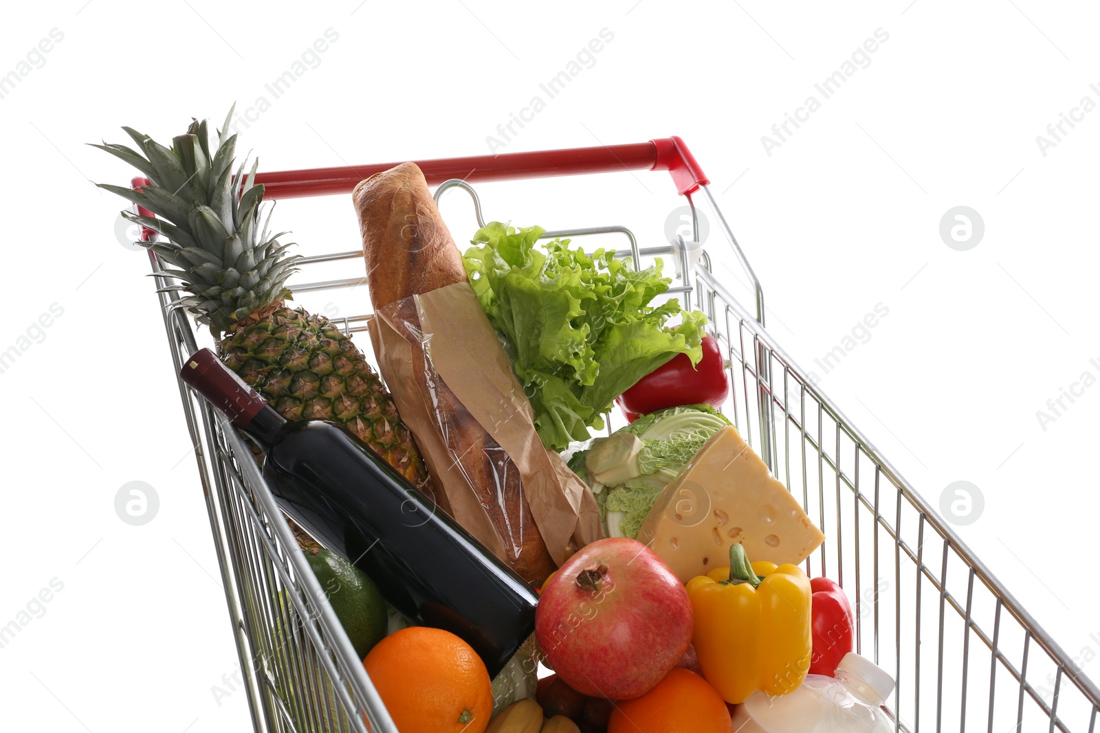 Photo of Shopping cart with groceries on white background