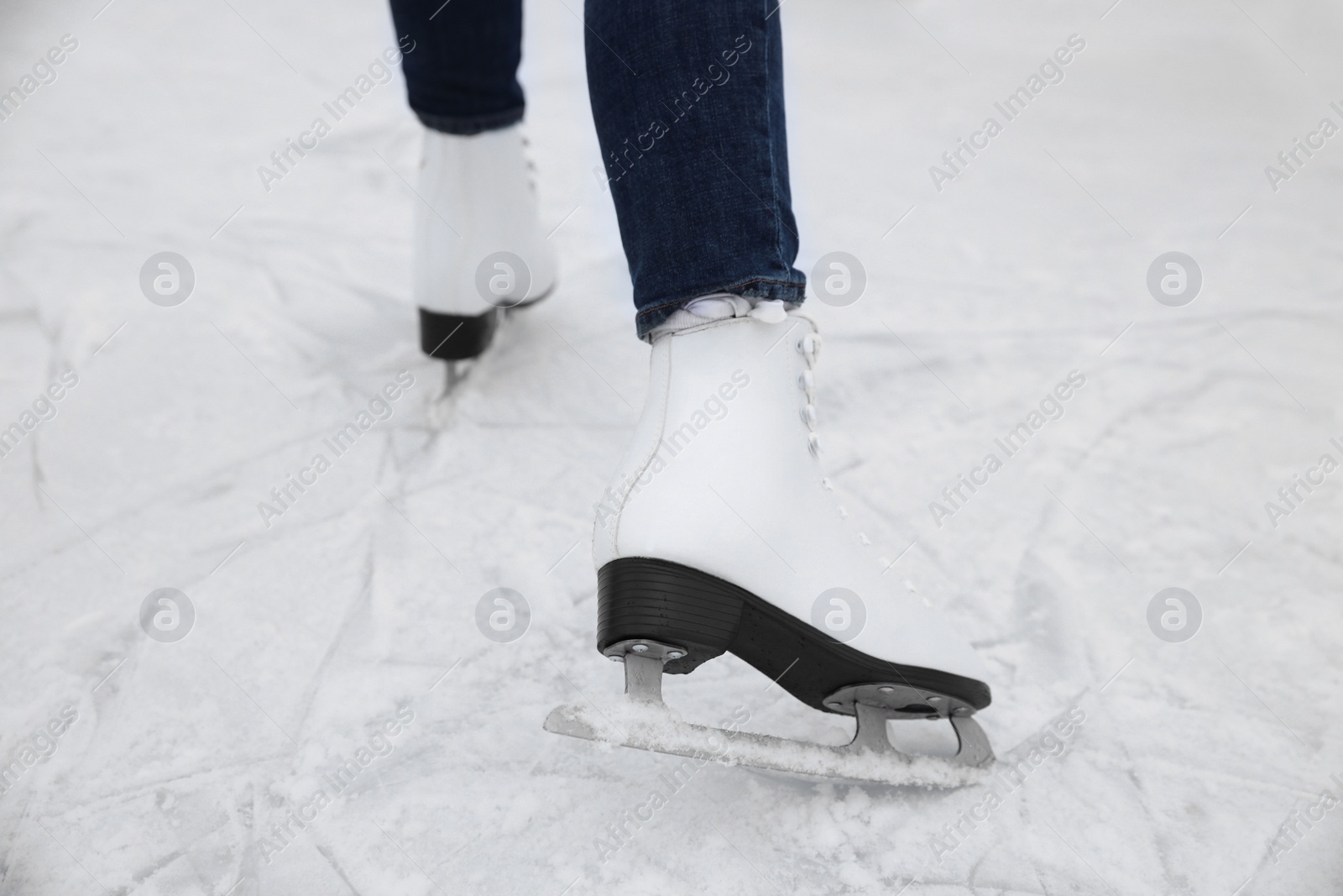 Photo of Woman skating along ice rink outdoors, closeup