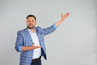 Photo of Portrait of happy mature man on light grey background