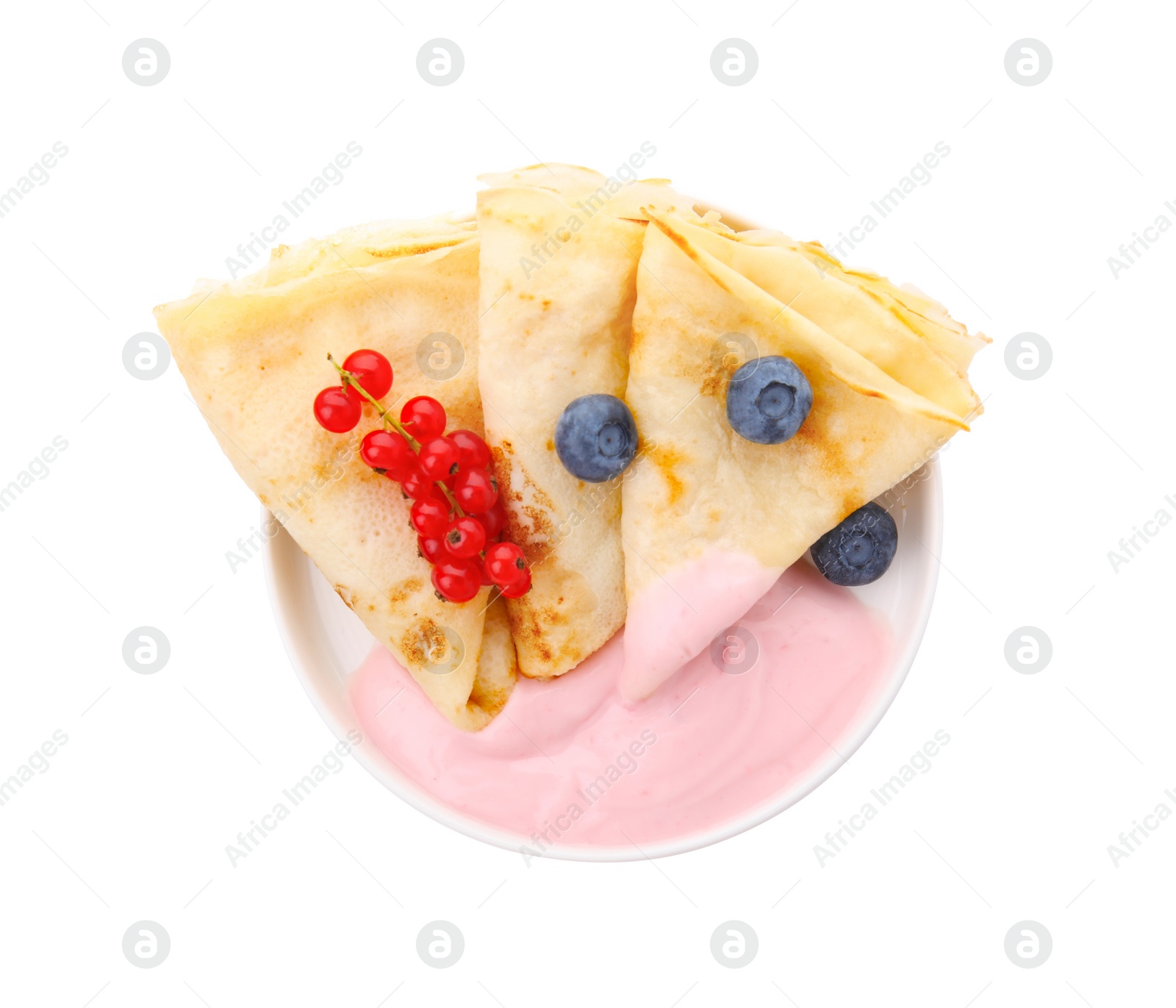 Photo of Delicious crepes with natural yogurt, blueberries and red currants on white background, top view