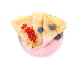 Delicious crepes with natural yogurt, blueberries and red currants on white background, top view