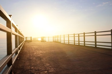 Photo of Picturesque view of empty pier at sunrise