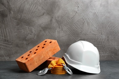 Photo of Composition with construction tools on grey table, space for text