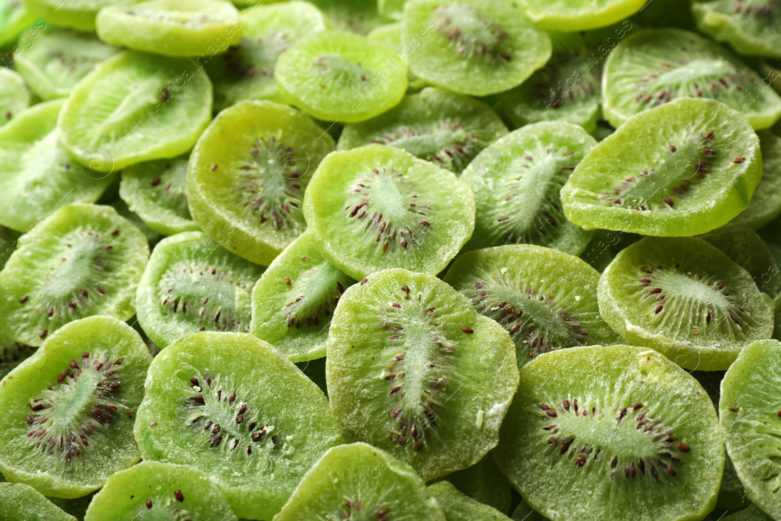 Photo of Tasty slices of kiwi as background, closeup. Dried fruit as healthy food