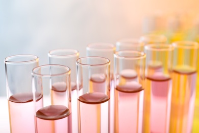 Photo of Closeup view of many test tubes with liquid, color tone effect