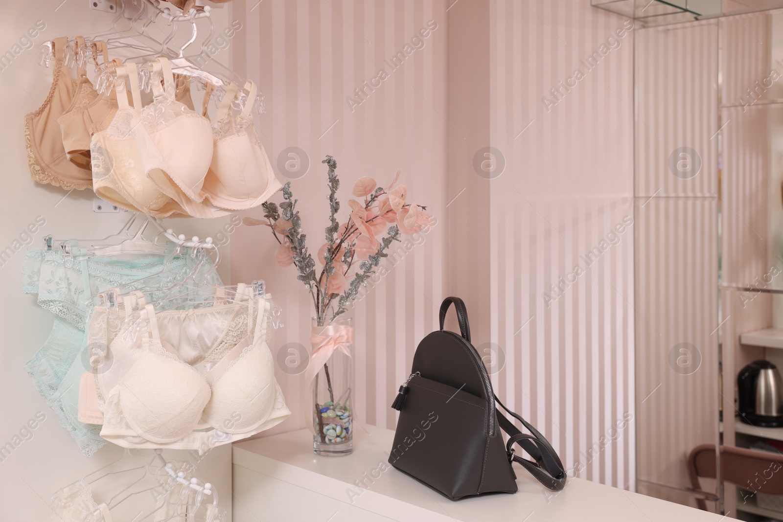 Photo of Luxury women's underwear on hangers in lingerie store