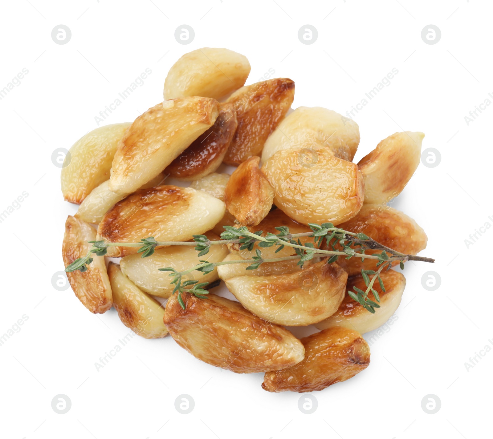 Photo of Fried garlic cloves and thyme isolated on white, top view