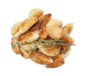 Photo of Fried garlic cloves and thyme isolated on white, top view