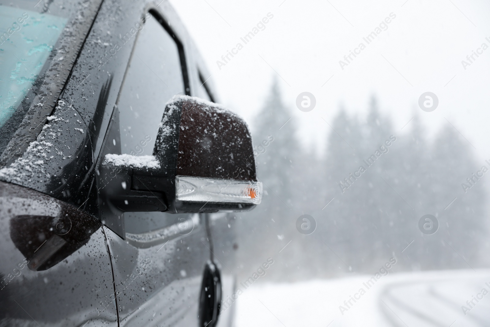 Photo of Car on snowy winter day, closeup view. Space for text