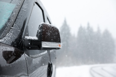 Photo of Car on snowy winter day, closeup view. Space for text