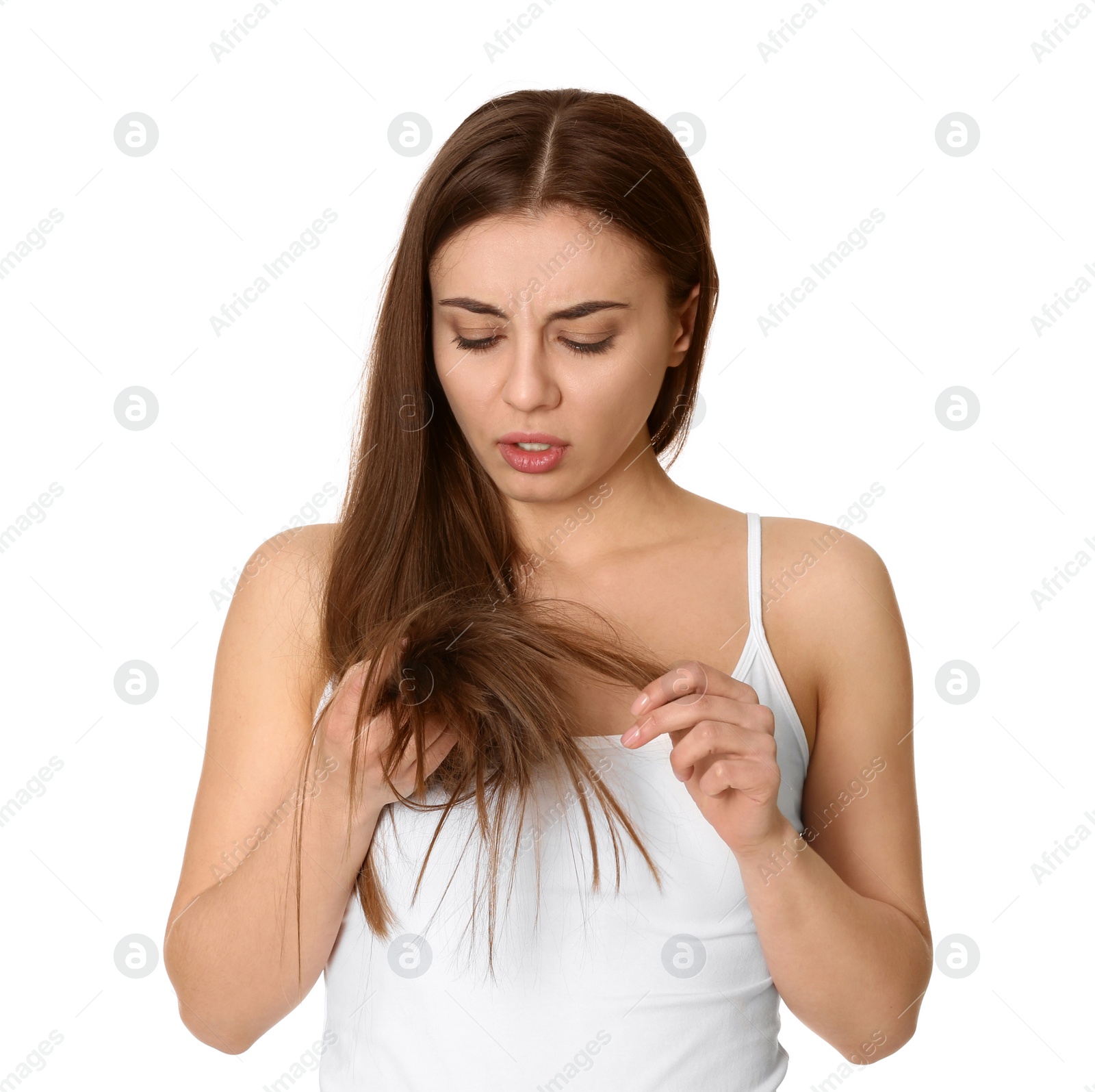 Photo of Emotional woman with damaged hair on white background. Split ends