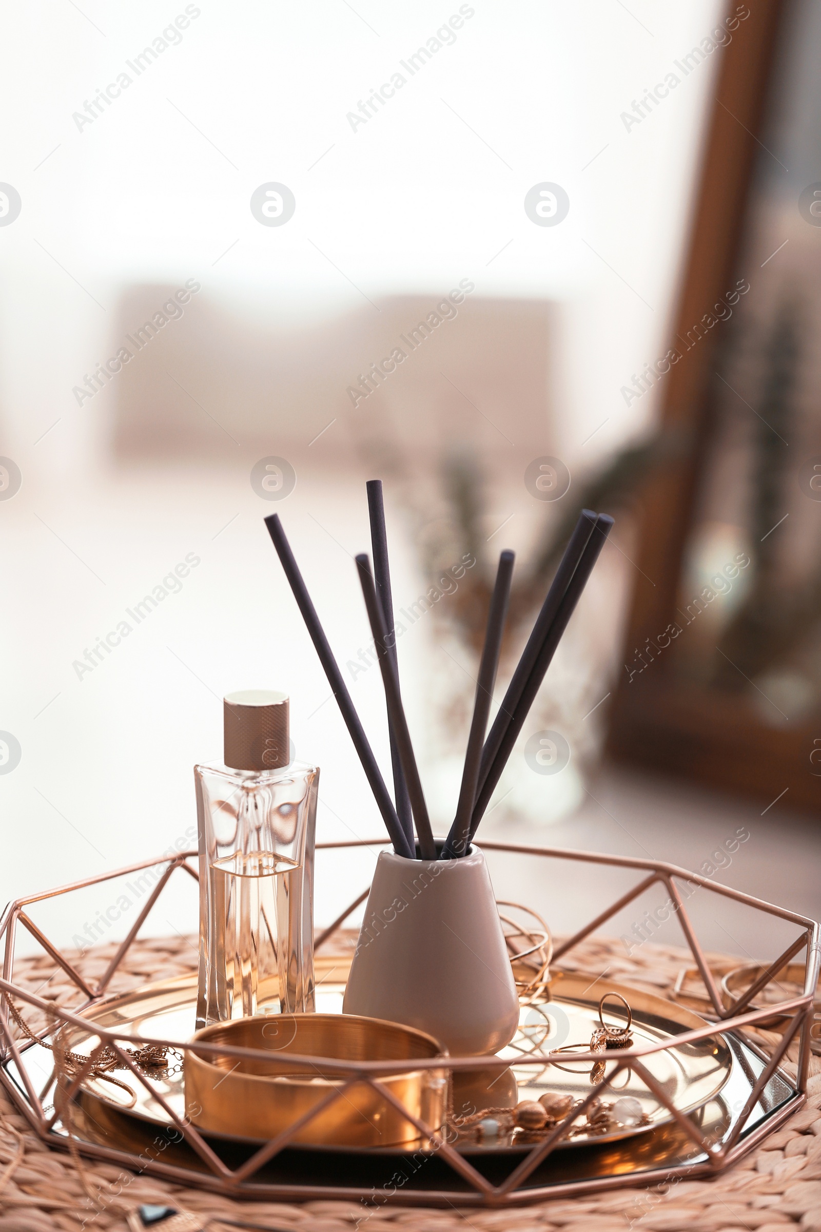 Photo of Composition with stylish accessories and interior elements on wicker pouf indoors